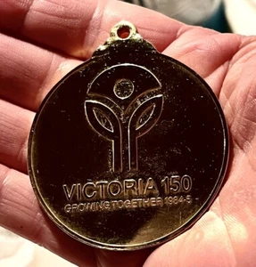 RARE Comm Gold Medal In Plastic Pouch; Australia Games ‘85 & Back -Victoria 150 - Picture 1 of 3