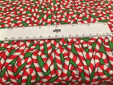 Christmas Candy Canes tossed on green fabric- Sold BT Fat Quarter