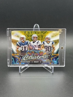 2024 Star Clusters Gold Topps Cosmic Tom Brady/Rob Gronkowski/Amendola Gold /50 - Image 1 of 3