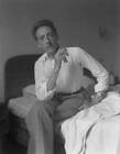Writer Jean Cocteau Portrayed Sitting On His Bed Smoking A C - 1947 Venice photo
