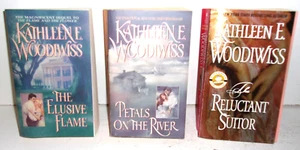 3 Kathleen E. Woodiwiss Books The Elusive Flame, Petals on the River, Reluctant - Picture 1 of 3