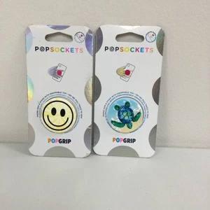 SET BESTEHEND AUS 2 Popsockets Popgrip Handy Griff & Ständer Smiley Gesicht & Schildkröte - Bild 1 von 5