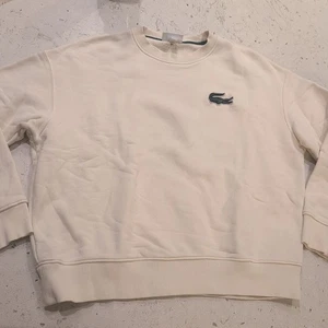 Sudadera LACOSTE UNISEX Ajuste Suelto Insignia Acento Logo Polar Crew L Crema $155 - Imagen 1 de 15
