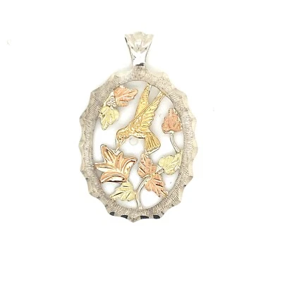 COLGANTE COLIBRÍ LANDSTROM PLATA ESTERLINA Y ORO COLINAS NEGRAS DE 10KT 6,1 GRAMOS Foto 1 de 4