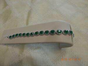 Rhodium plated copper bracelet with green cubic zirconia stones, white CZ accent