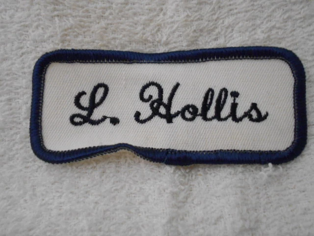 L. HOLLIS  USED EMBROIDERED  SEW ON NAME PATCH TAGS DARK BLUE ON WHITE - Image 1 of 1