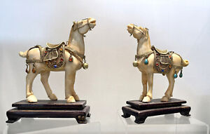 TWO antique hand-carved horses, cattle bone, gold saddles, museum quality