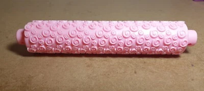 Plastic pink embossed rolling pin. Swirl pattern. 10.5" length. - Image 1 of 4