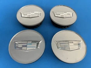 CADILLAC GENUINE FACTORY ORIGINAL OEM SILVER CENTER CAPS 9597375 OEM SET OF 4 - Picture 1 of 9