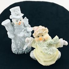 2 Happy Pastel Colored Snowman and Woman Dancing Christmas Ornaments.