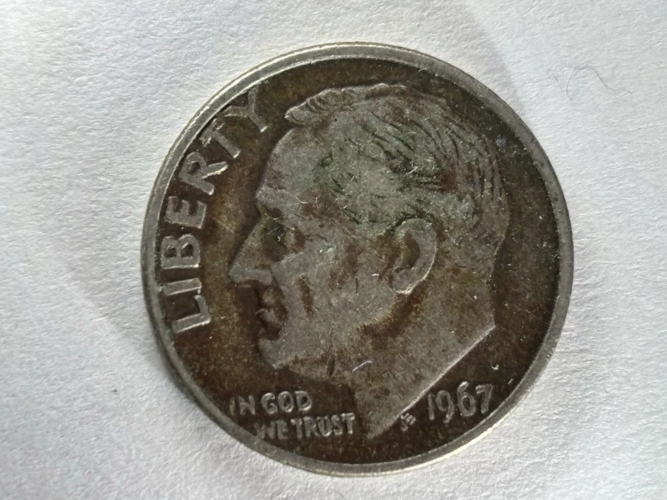 For sale is a 1967 Roosevelt Dime featuring a genuine No Mint Mark Major error.  - Image 1 of 3