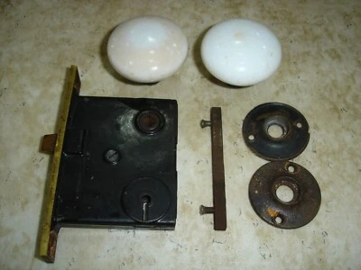 VINTAGE WHITE DOOR KNOBS W/LOCK SET, BACKING PLATES, BRASS FACE PLATE, STEM - Image 1 of 4