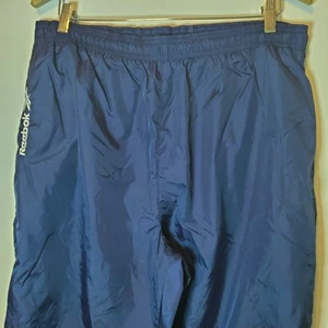 Pantalones deportivos Reebok para hombre XL azul marino calce suelto forrados cremallera pierna cortavientos nailon - Imagen 1 de 9