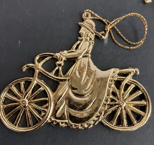 Witch Christmas Ornament Victorian Gold Metal Witch Riding Bicycle Woman Dress - Picture 1 of 8