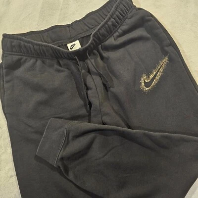 Pantalones de chándal Nike Sportswear medianos negros polvo de estrellas polar dorado Swoosh usados en excelente estado Foto 1 de 4