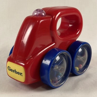 Juguete rodante vintage Gerber Baby Sonajero rojo coche camión ruedas azules Foto 1 de 4
