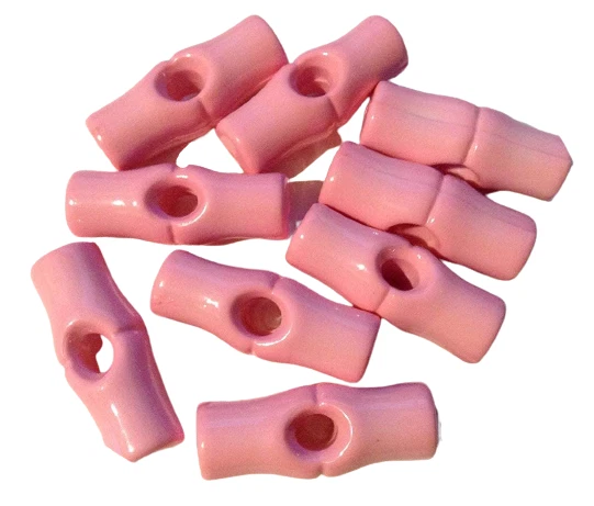8 x 25mm Plastic Toggle Buttons in baby pink. - Image 1 of 1