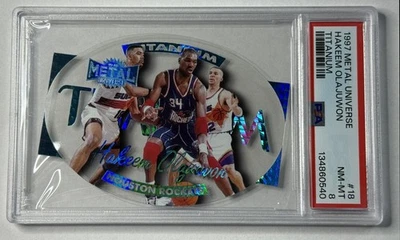 HAKEEM OLAJUWON PSA 8 1997-98 SKYBOX METAL UNIVERSE #18 TITANIUM ROCKETS SP - Image 1 of 2