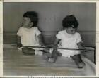 1935 Press Photo Annette studies yardstick while Yvonne looks elsewhere