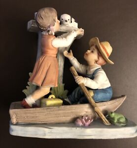 Boy And Girl In Row Boat W/ Spotted Puppy Figurine