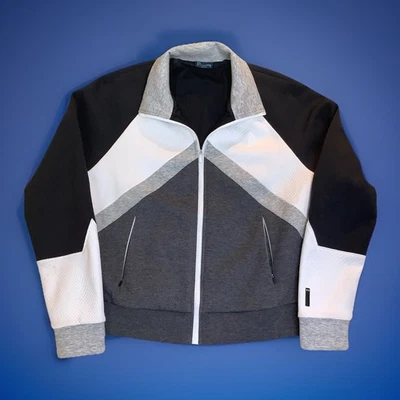 Jaqueta Under Armour feminina colorblock preto branco cinza bolsos com zíper GG - Imagem 1 de 4