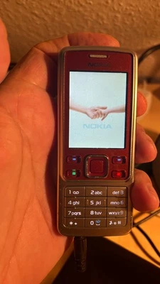 2 x Nokia Handy 6300, gebraucht, ohne SIM Look, Schwarz und Rot - Bild 1 von 4