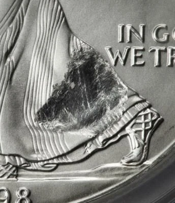 1998 NGC MS68 Large Struck Thru & Retained Plastic Silver Dollar SAE Mint Error - Image 1 of 4