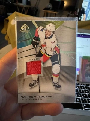 2019-20 Upper Deck SP Game Used - Matthew Tkachuk #54 Gold Jersey Relics (MEM) - Image 1 of 2