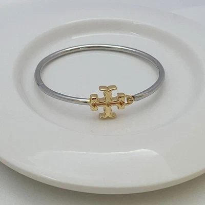 ¡Oferta de verano! Brazalete con bisagras Tory Burch Eleanor combinado de oro y plata 💛🩶 Foto 1 de 4