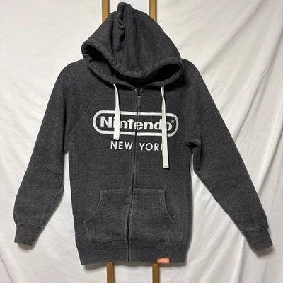 Sudadera con Capucha Nintendo New York Para Hombre Grande Gris Blanco Cremallera Completa Tienda NY Rara Foto 1 de 4