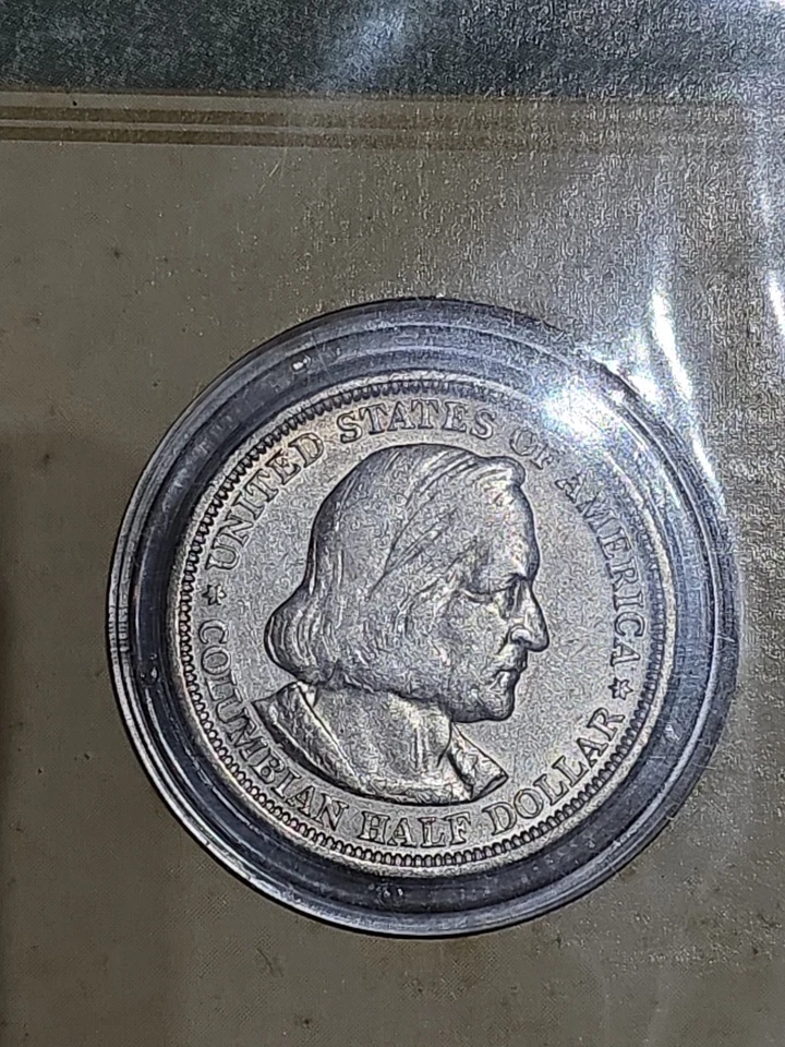 U.S. mint 1893 Colombian Exposition Half Dollar 90% Silver AU. Original book. - Image 1 of 4