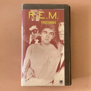 R.E.M. Succumbs (VHS, 1987) REM. Pre-Owned BROWN CLAMSHELL Original Receipt - Picture 1 of 17