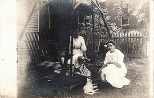 RPPC Group 2 Women Young Child Cat at a Backyard Swing Set • Stamp Box 1904-1920 - Picture 1 of 2