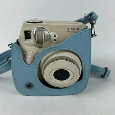 Cámara fotográfica Fujifilm Instax Mini 7S blanca crema con estuche azul solo para piezas Foto 1 de 4