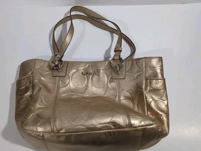 Bolso de Mano Coach Metálico Dorado East West Firma Cuero Foto 1 de 4