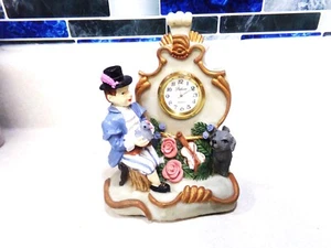 FIGURA DE COLECCIÓN HOMBRE SENTADO POR RELOJ SOSTENIENDO UN PÁJARO Y CON RESINA DE PERRO - Imagen 1 de 7