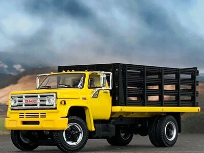 1/64 DCP YELLOW/BLACK GMC 6500 SINGLE AXLE STAKE BED - Image 1 of 4