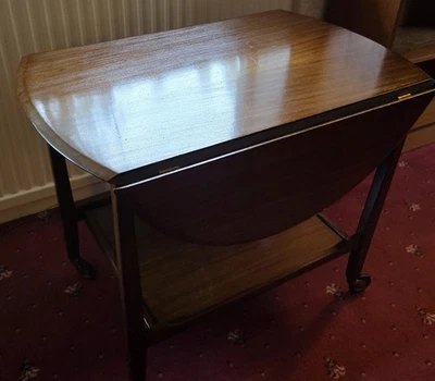SMALL VINTAGE WOODEN DROP LEAF  TABLE WITH SHELF UNDERNEATH AND ON CASTERS - Image 1 of 4