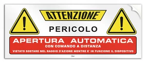 Cartello in PVC adesivo "Attenzione apertura automatica comandata a distanza" - Imagen 1 de 5