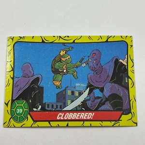1989 Topps TMNT Teenage Mutant Ninja Turtles #39 Clobbered Evil Ninja Androids - Imagen 1 de 2
