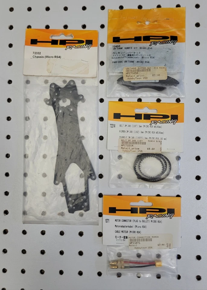 HPI Racing ~ Micro RS4 ~ 4 Item Parts Lot ~ Chassis, Belt, Bumpers, Plug NIP NOS - Image 1 of 4