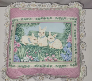 3 almohadas de conejo sentado en un banco de jardín flecos de oro rosa 13" x 12" - Imagen 1 de 3