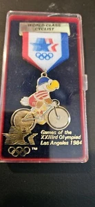 1984 L.A. Los Angeles Olympics World Class Cyclist Eagle Ribbon Pin NEW - Picture 1 of 4