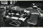 1991 Press Photo Rescue Members Move Car Accident Victim To Ambulance