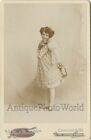 Cute girl actress in great dress antique cabinet photo