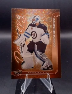 2024-25 Upper Deck Series 1 - Dazzlers Connor Hellebuyck #DZ-48 Orange - Bild 1 von 2