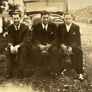 Fotografía de grupo instantánea antigua hombres guapos sentados en parachoques de coche por carretera - Imagen 1 de 8