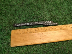 LE SABRE CUSTOM BY BUICK OEM DASHBOARD EMBLEM #25667560-01 3S8 - Picture 1 of 5