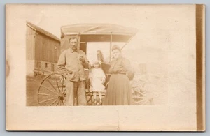 Postcard RPPC Simply Dressed Family Standing by Early Model Automobile c1910s - Picture 1 of 2