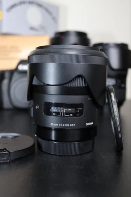 Lente principal Sigma 35 mm F1.4 Art DG HSM 012 para montaje Canon EF con filtro UV + capucha Foto 1 de 4